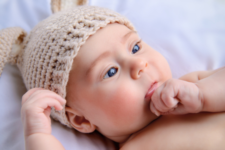 Cute little baby lying on the blanket in rabbit costume. Family concept. Easter holiday.の写真素材