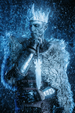 Halloween. The King zombie warrior in the armor of a medieval knight covered with snow. Horror fantasy film.の写真素材