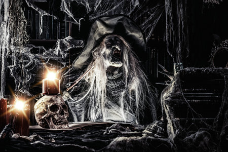 A witch holding a magic stick. Halloween. Horror movie.の写真素材