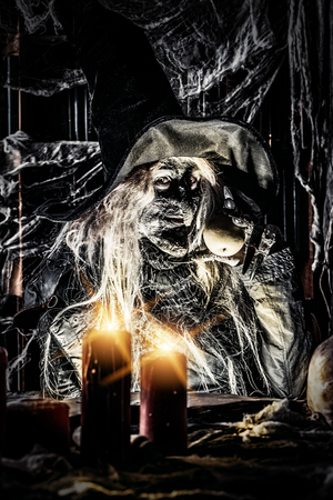 A witch holding an apple. Halloween. Horror movie.の写真素材