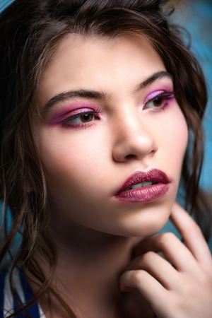 Close-up portrait of a attractive girl posing in studio. Beauty, fashion. Make-up and cosmetics concept.の写真素材