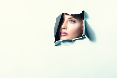 Beautiful lady looking from behind background. Beauty, make up.の写真素材