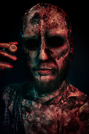 A zombie smoking a cigar. Halloween. Horror film.の写真素材