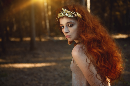 Portrait of a enigmatic beautiful girl posing in a forest. Beauty, fashion. Cosmetics and makeup.の写真素材