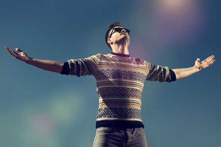 A portrait of a handsome man over the sky. Autumn fashion for men. Freedom, lifestyle.の写真素材