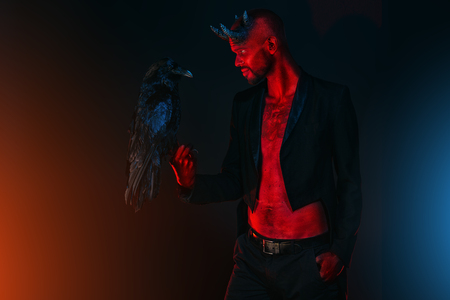 A portrait of a bad demon with a black raven. Horror movie, nightmare. Halloween.の写真素材