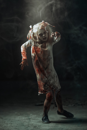 A full length portrait of a scary girl. Halloween. Horror film.の写真素材