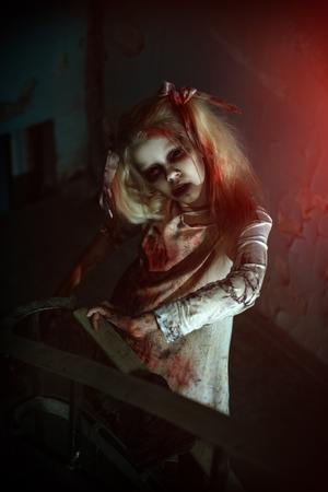 Scary zombie girl is standing on the stairs. Halloween. Horror movie.の写真素材