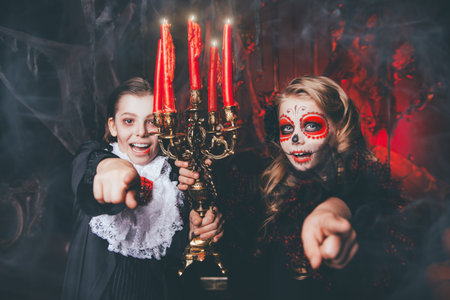 Halloween. Two children in carnival costumes scare in the old castle.の写真素材