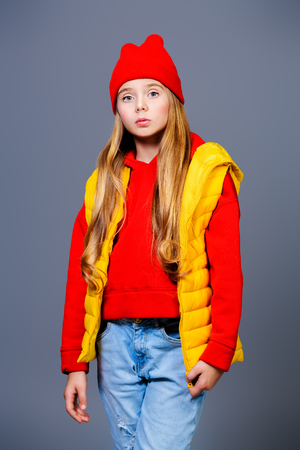 A funny girl in bright casual clothes posing in studio. Beauty, fashion for kids.の写真素材