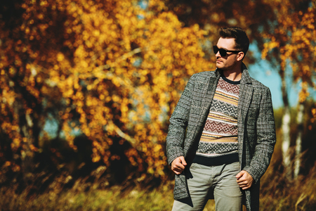 A handsome man in countryside. Autumn fashion for men. Freedom, lifestyle.の写真素材