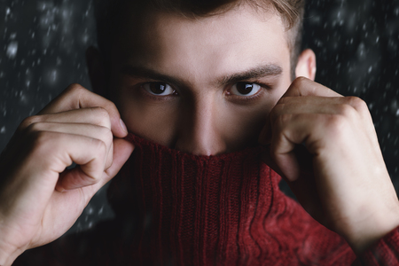 Portrait of a handsome young man in a warm sweater.の写真素材