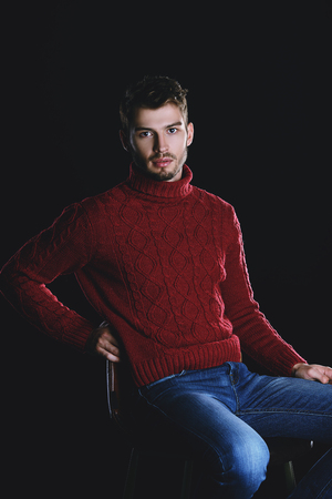 Portrait of a handsome young man in a warm sweater.の写真素材