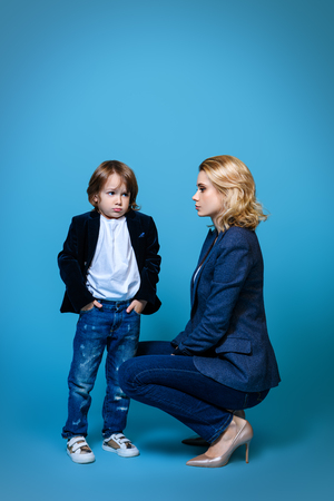 Mother and her son are posing in the studio and wearing casual clothes. Family, fashion.の写真素材