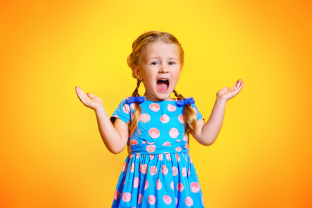 A portrait of a positive young pretty girl. Summer bright fashion for kids.の写真素材