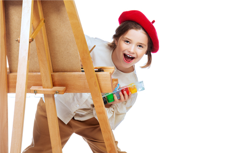 A portrait of a positive girl painting a picture. Creativity, artist.の写真素材