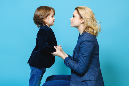 Mother and her son are posing in the studio and wearing casual clothes. Family, fashion.の写真素材