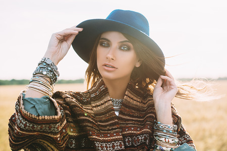 Romantic young woman on a background of a golden wheaten field. Beauty, fashion.の写真素材