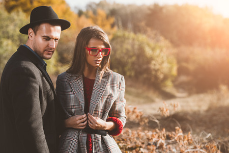 Portrait of a beautiful young people walking in the autumn park. Autumn fashion.の写真素材