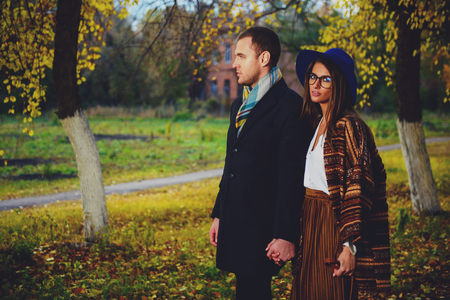 Portrait of a beautiful young people walking in the autumn park. Autumn fashion.の写真素材