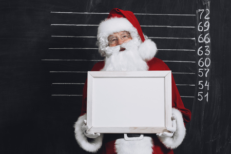 A portrait of Santa Claus in sunglasses holding a plate. Merry Christmas and Happy New Year!の写真素材