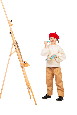 A full length portrait of a girl painting a picture. Creativity, artist.の写真素材