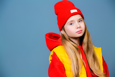 A close-up of a funny girl in bright casual clothes posing in studio. Beauty, fashion for kids.の写真素材
