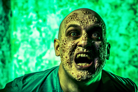 A portrait of a sick scientist after a failed experiment in the green light. desperation, hopelessness. Horror, halloween.の写真素材
