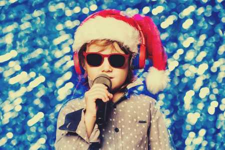 A young boy is singing a song. Merry Christmas and Happy New Year.