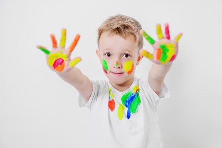 A portrait of a cute boy in colorful paints. Childhood, leisure activities.の写真素材