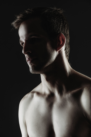 A portrait of a handsome athletic man in a studio.  Fashion, beauty concept.の写真素材