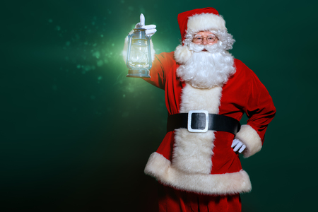 A portrait of Santa Claus holding a lantern. Merry Christmas and Happy New Year!の写真素材