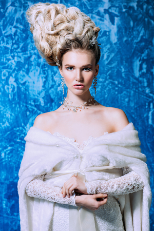 A portrait of a cold beautiful lady wearing a tight dress. The snow Queen. Beauty,cosmetics, hairstyle, fashion.の写真素材