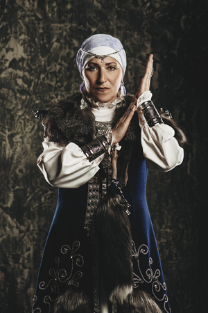 Mature woman in ethnic costume posing in studio.の写真素材