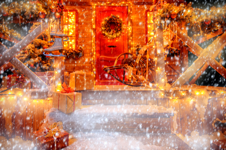 A porch decorated with luminous garlands for Christmas at home. Decorations for Christmas and New year. Magic miracle time.の写真素材