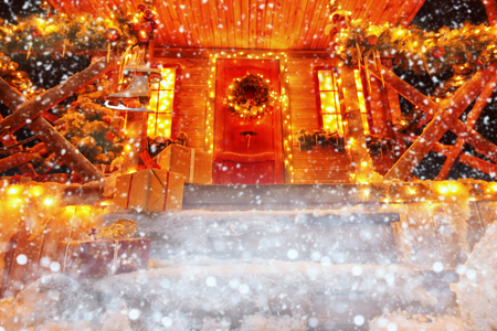 A porch decorated with luminous garlands for Christmas at home. Decorations for Christmas and New year. Magic miracle time.の写真素材