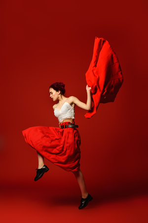 Beautiful girl with pink hair wearing bright clothes over red background. Bright style, fashion. Full length portrait.の写真素材