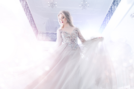 A portrait of a beautiful elegant woman in the fluttering wedding dress. Fashion, wedding dress.の写真素材