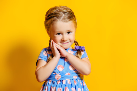 A portrait of a positive young pretty girl. Summer bright fashion for kids.の写真素材