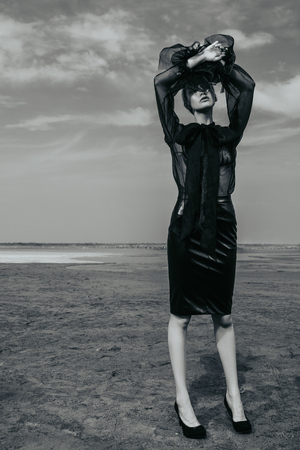 Portrait of a beautiful gothic woman in black clothes posing outdoor. Beauty, fashion.の写真素材