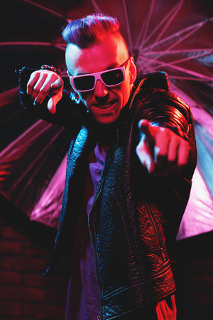 Portrait of a crazy disco man. Party, disco. Colorful light.の写真素材