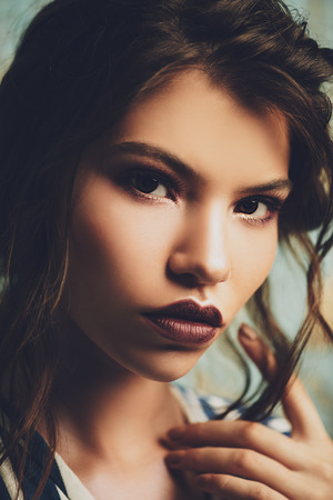 Close-up portrait of a attractive girl posing in studio. Beauty, fashion. Make-up and cosmetics concept.の写真素材