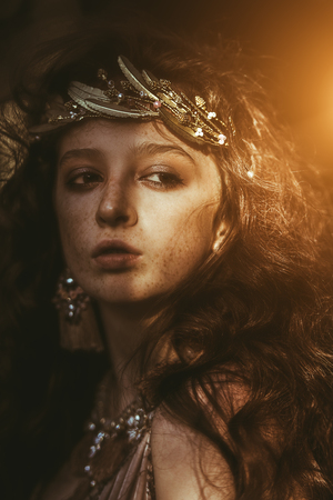 Portrait of a enigmatic beautiful girl posing in a forest. Beauty, fashion. Cosmetics and makeup.の写真素材