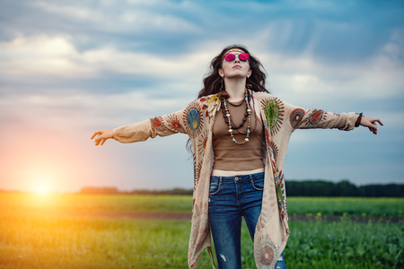 Beautiful hippie girl posing outdoor. Contemporary bohemian style. Spirit of freedom. Fashion shot. Bohemian, bo-ho style.の写真素材