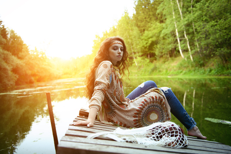 Beautiful hippie girl posing outdoor. Contemporary bohemian style. Spirit of freedom. Fashion shot. Bohemian, bo-ho style.の写真素材