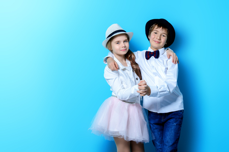 Happy children are posing on blue  background. Happy childhood. Spring holidays.の写真素材
