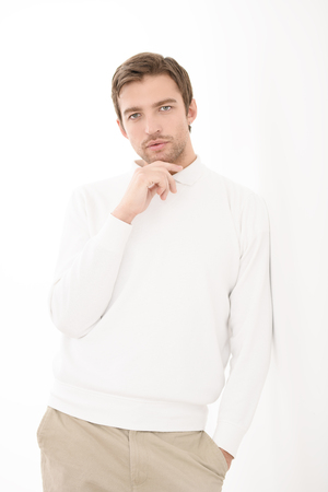 A portrait of a handsome man in white over the white background. Beauty, fashion for men.の写真素材