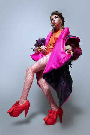 Vogue shot of a female model posing at studio. Fashion collection. Full length portrait over white background.の写真素材