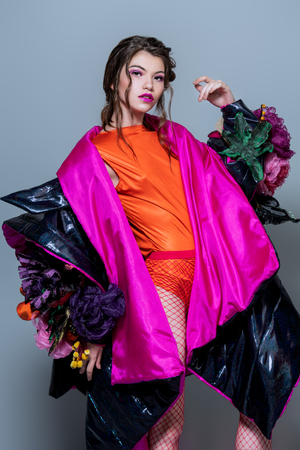 Vogue shot of a female model posing at studio. Fashion collection. Portrait over gray background.の写真素材