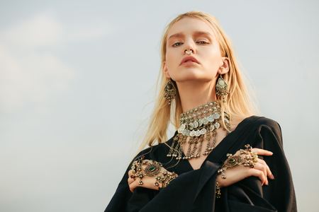 Portrait of a beautiful woman in black clothes posing outdoor. Beauty, fashion.の写真素材